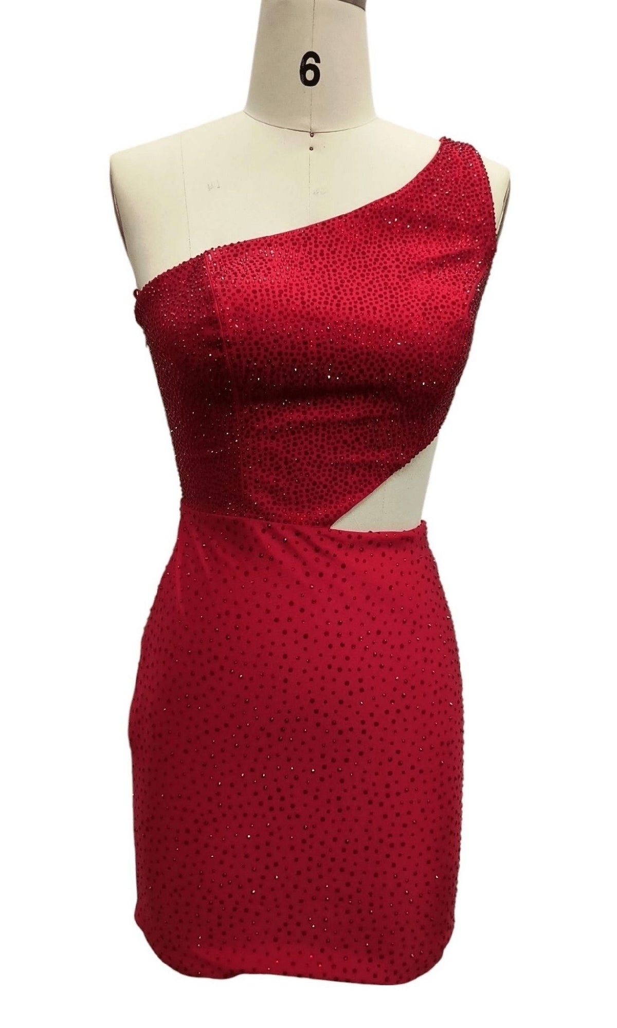The Cut-Out Short Red Hoco Dress: 12416 features a bold one-shoulder design, side cutout, and sparkling embellishments—a striking short red party dress ideal for making a statement at homecoming.